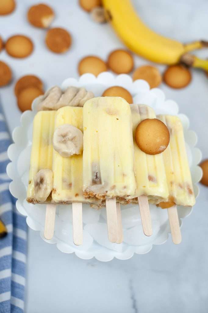 Banana Pudding Popsicles 3 Banana Pudding Popsicles with vanilla wafers surrounding.
