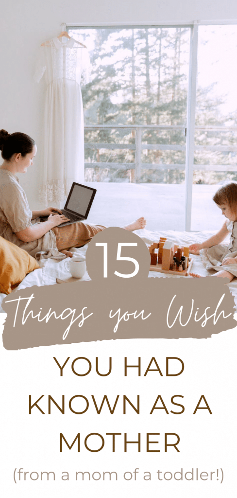 mom on computer with child playing next to her