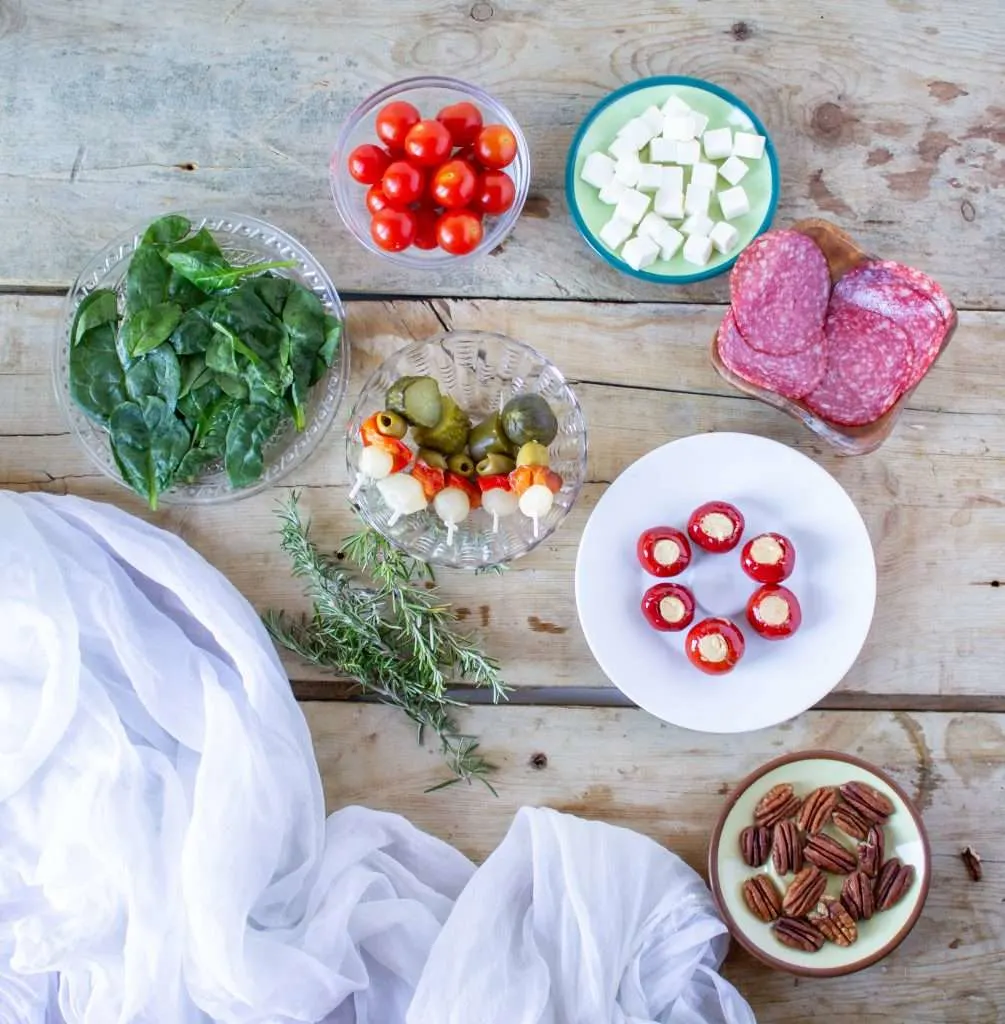 overhead view of Charcuterie Christmas Wreath ingredients in individual bowls 