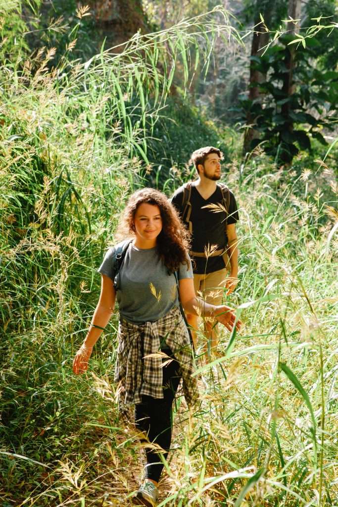 5 Cheap Date Night Ideas 4 couple hiking together in the woods 5 Cheap Date Night Ideas