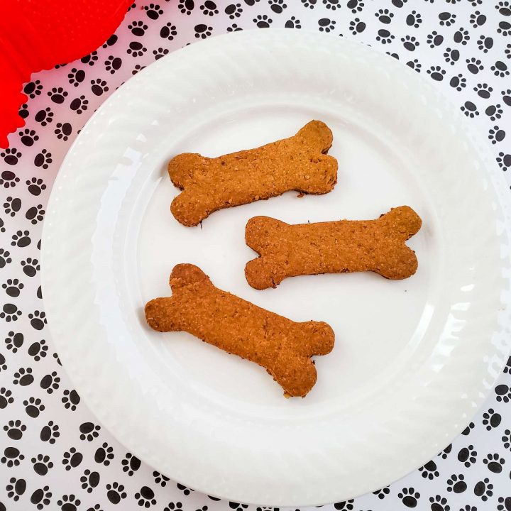 Crunchy Carrot & Oat Dog Biscuits on a white plate.