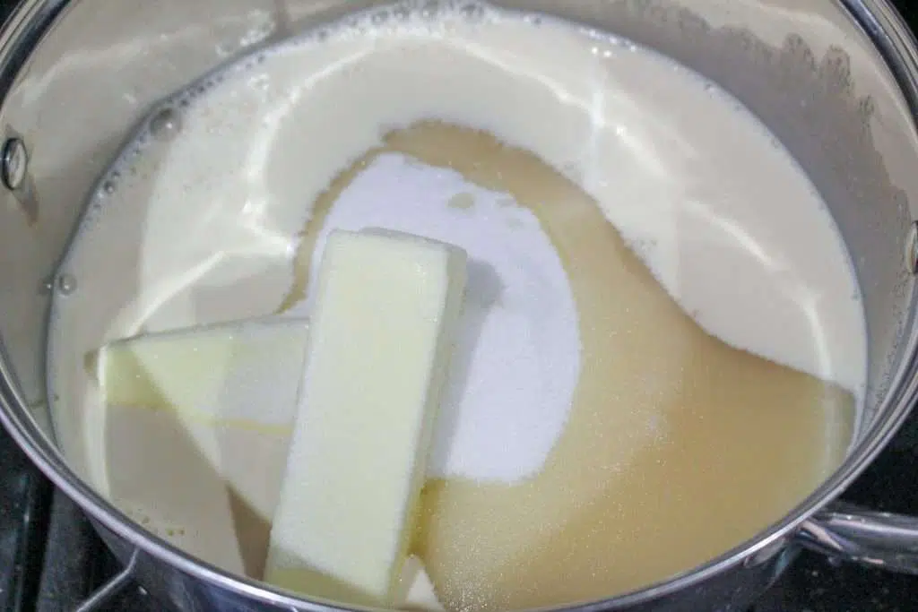 butter, sugar and evaporated milk melting in pan