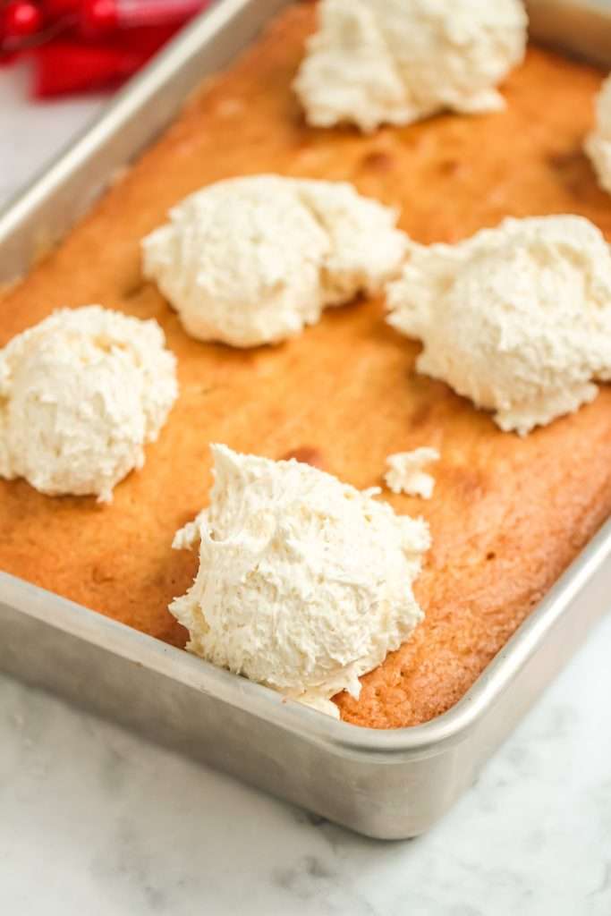 Quick and Easy Eggnog Cake 9 eggnog cake in pan with frosting dollops on top