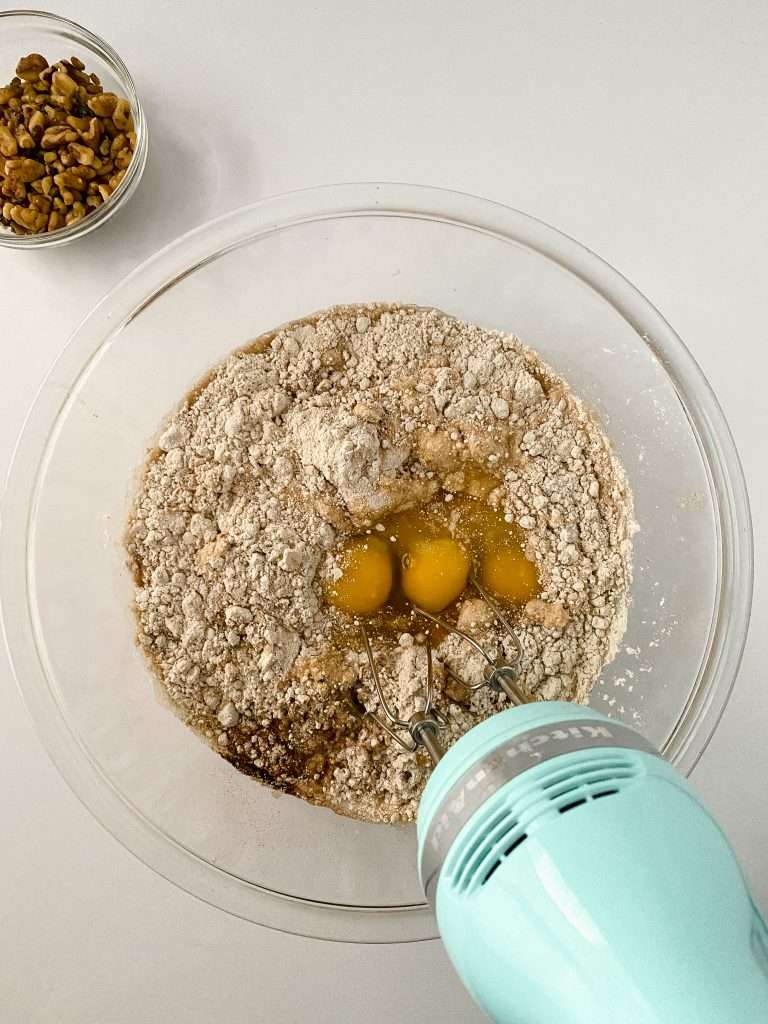 Apple Cider Cupcakes 8 Mixing bowl with apple cider cupcakes batter ingredients and an electric mixer.