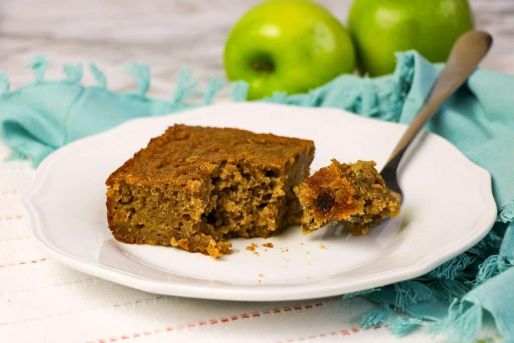 Homemade Old Fashioned Applesauce Spice Cake with Golden Raisins with a fork