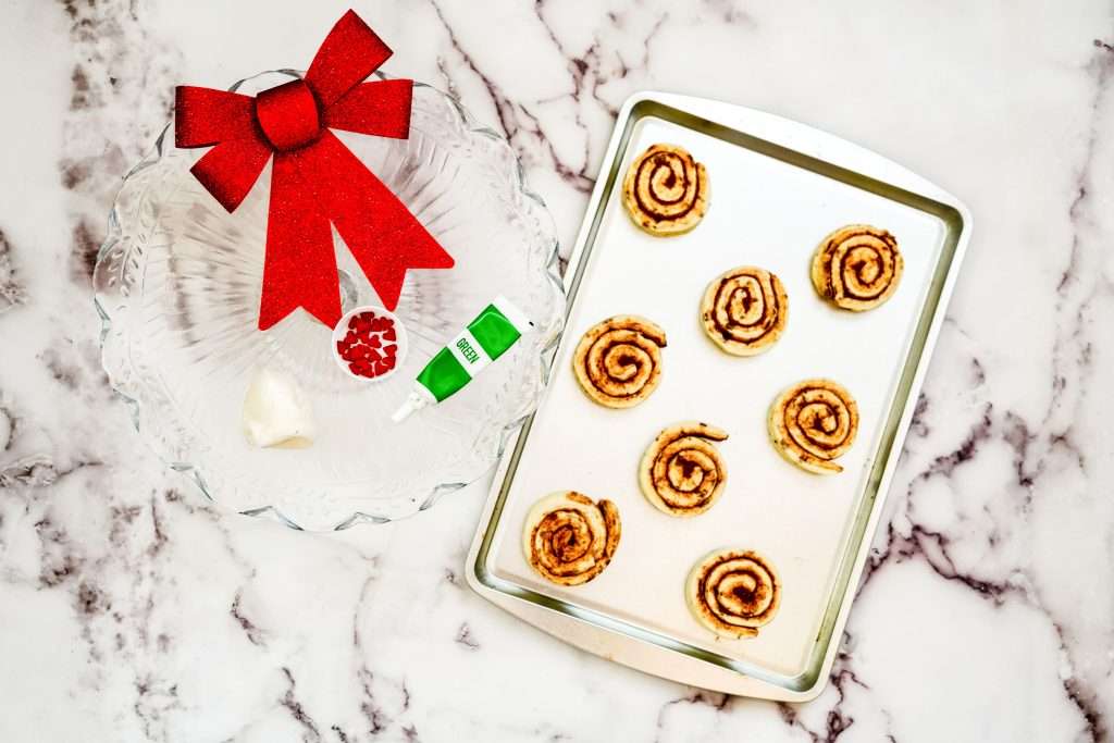 Grinch Christmas Cinnamon Rolls 7 cinnamon rolls on a baking sheet