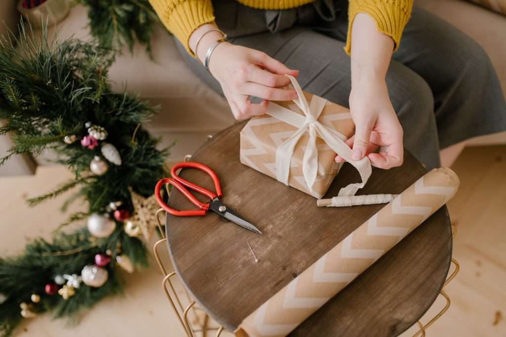 25 Stocking Stuffer Ideas for Kids Under 7 5 Woman wrapping a christmas present