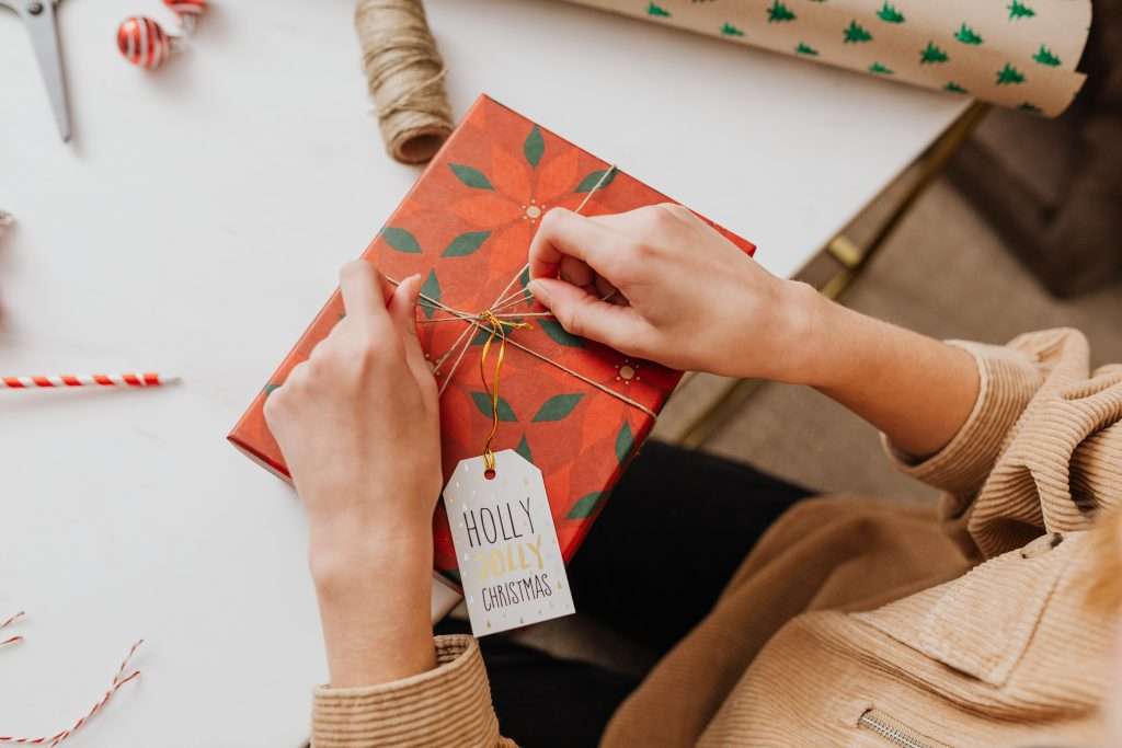 25 Stocking Stuffer Ideas for Kids Under 7 7 woman wrapping a christmas present