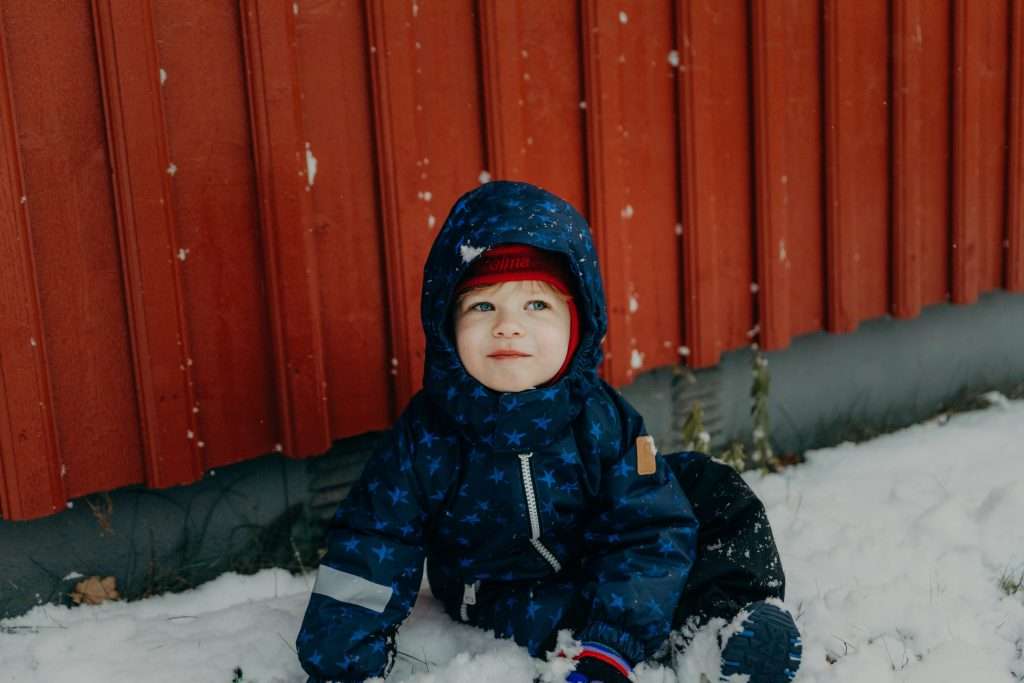 toddler playing in the snow