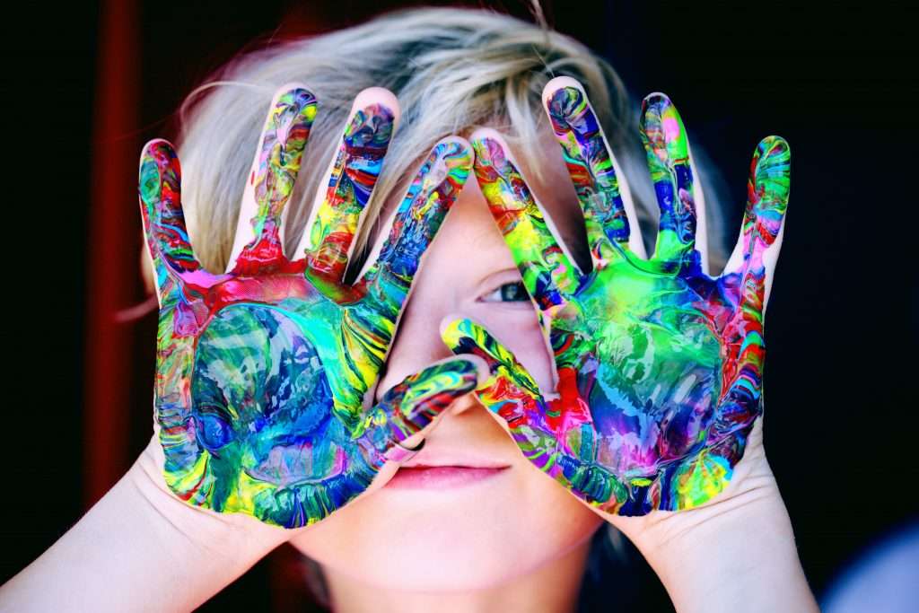 15 Winter Activities for Toddlers 7 toddler holding hands up finger painting