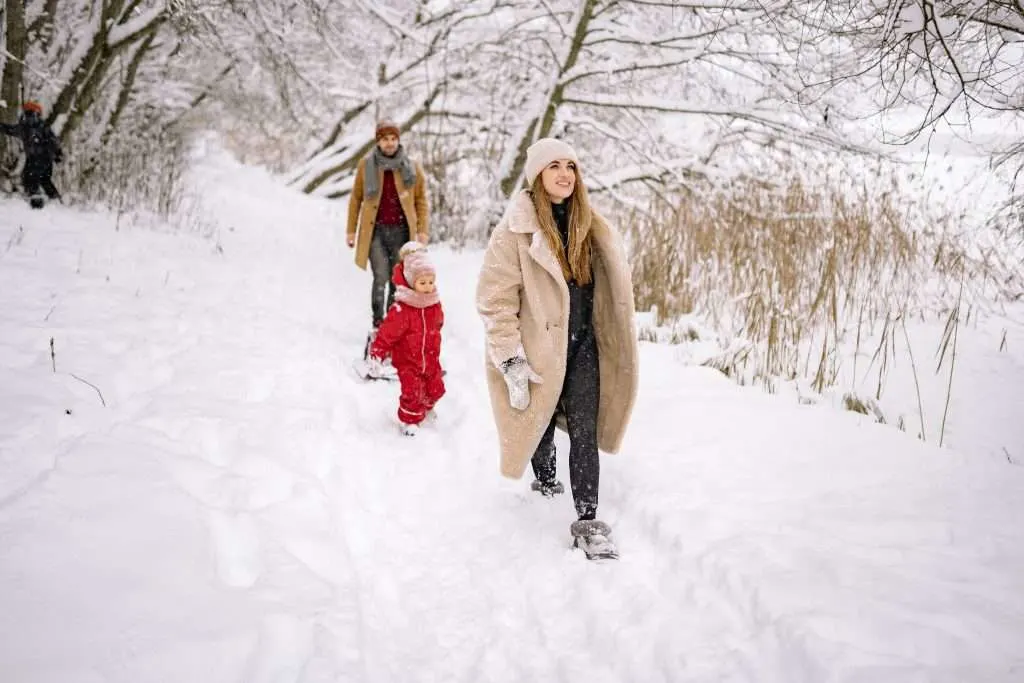 family hiking together in the snow