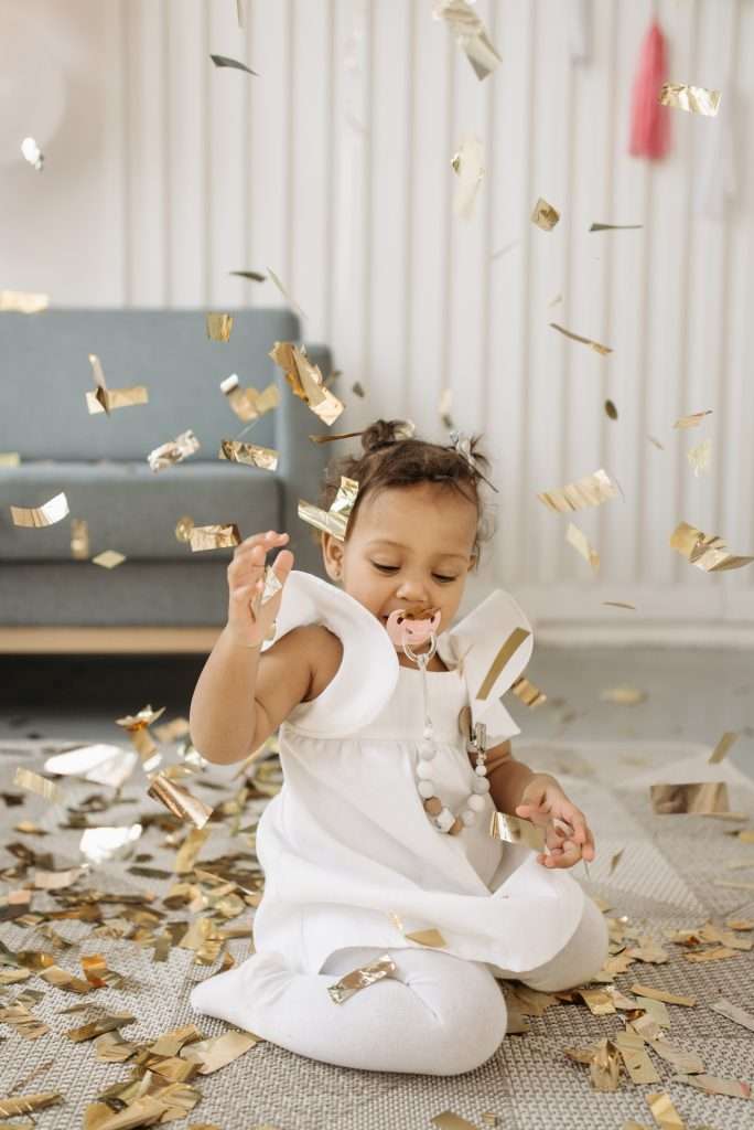 Things to Do with Kids on New Year’s Eve 7 toddler celebrating new year's eve with confetti