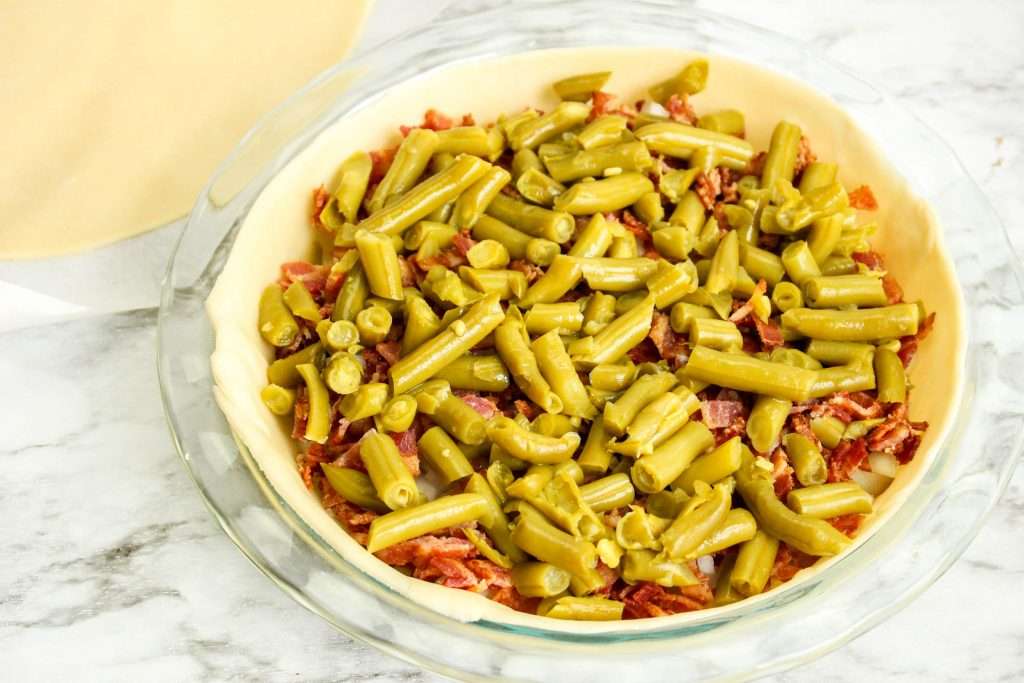 green beans and bacon in bowl with onions