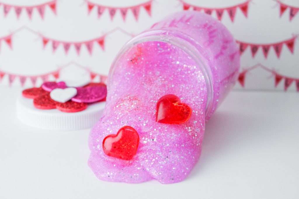 pink valentine's day slime in a clear container 