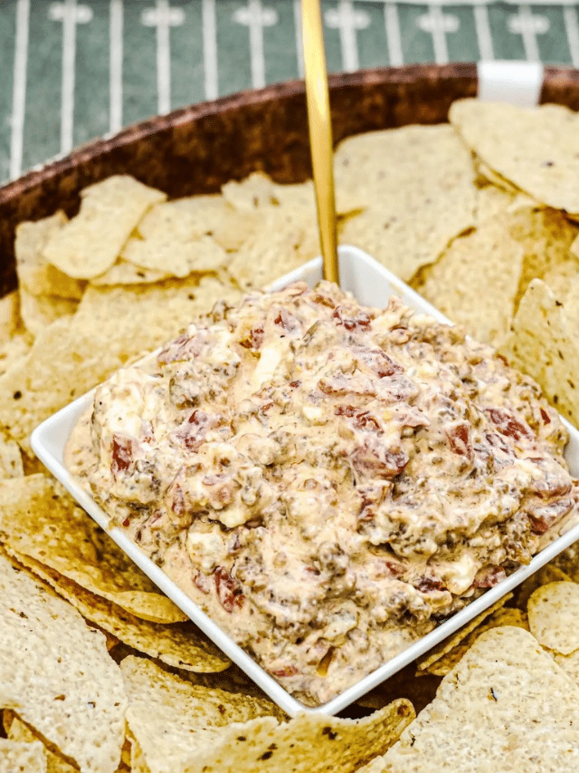 3 Ingredient Sausage Rotel Dip in a square white bowl. The bowl is surrounded with nachos.