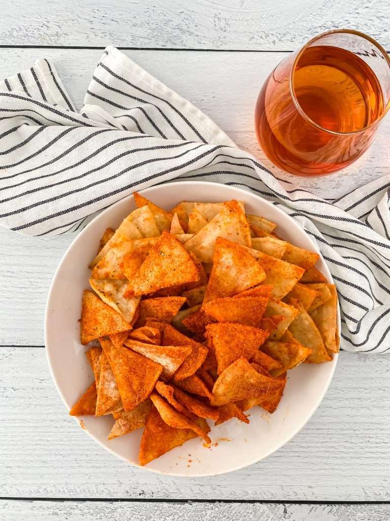 Homemade Doritos 11 homemade DIY doritos in a white bowl with a glass of wine