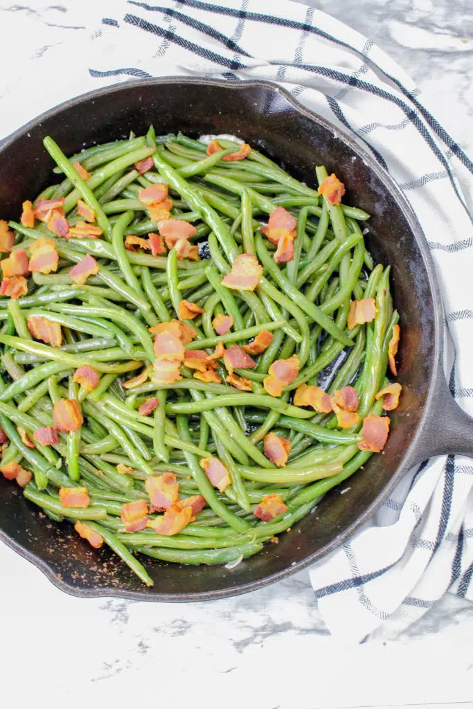 overview fresh green beans with bacon in a pan