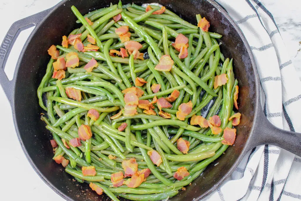 overview fresh green beans with bacon in a pan