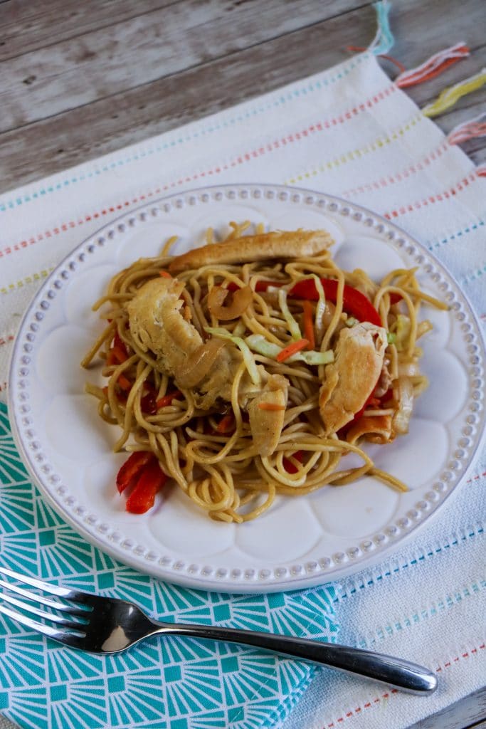 The Best 30 Minute Chicken Lo Mein Recipe 4 chicken lo mein on white plate with blue napkin and silver fork