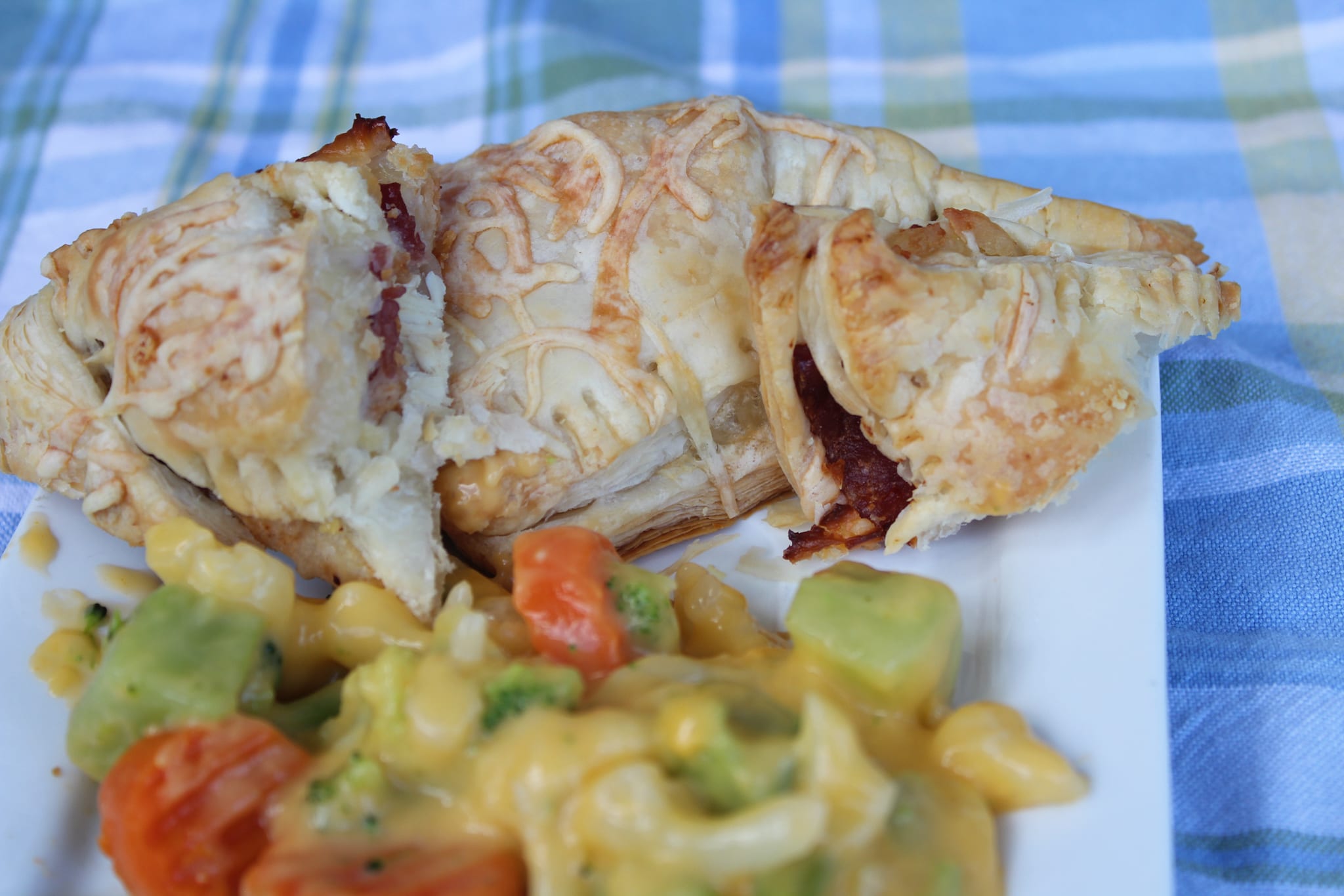 chicken turnovers with vegetables on white plate