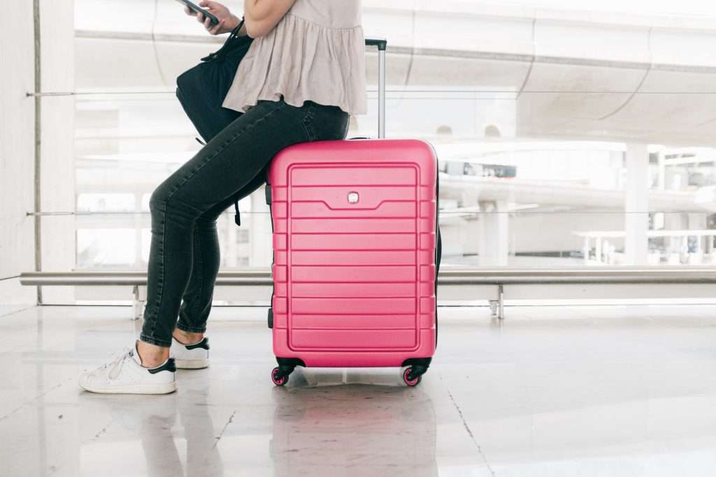 pink luggage suitcase in an airport