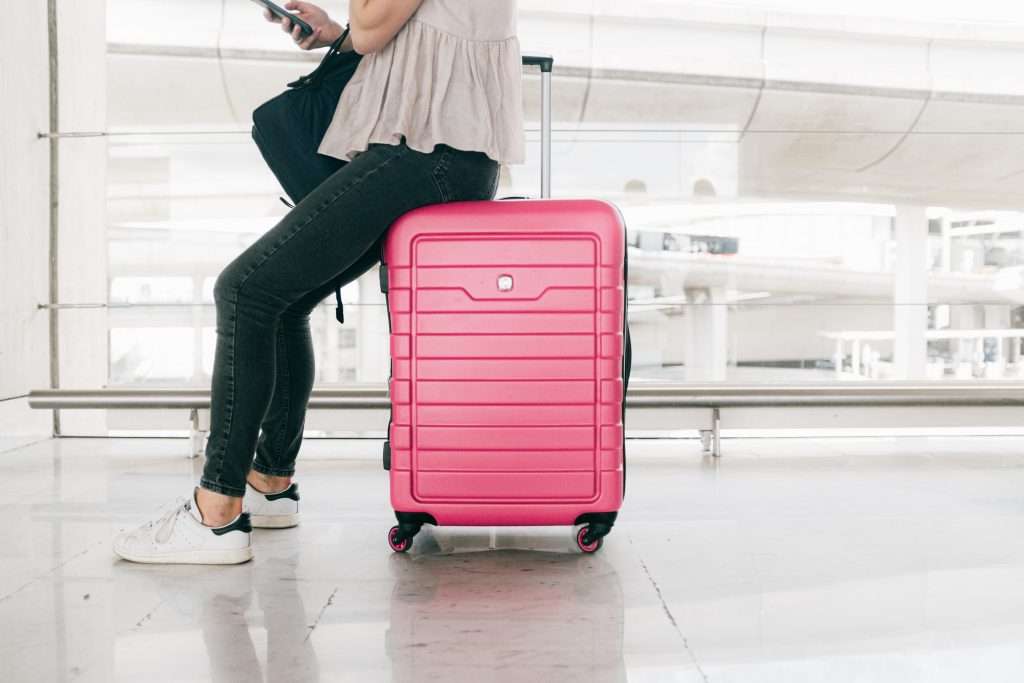 Ultimate Printable Disney Packing List: 75+ Things You May Need! 5 pink luggage suitcase in an airport