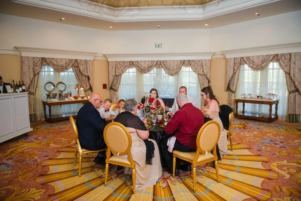 family having dinner at Disney World's Grand Floridian White Hall room and patio 