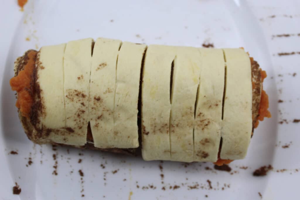 Pumpkin Cinnamon Rolls (3 Ingredients) 13 Pumpkin cinnamon rolls rolled up prior to baking.