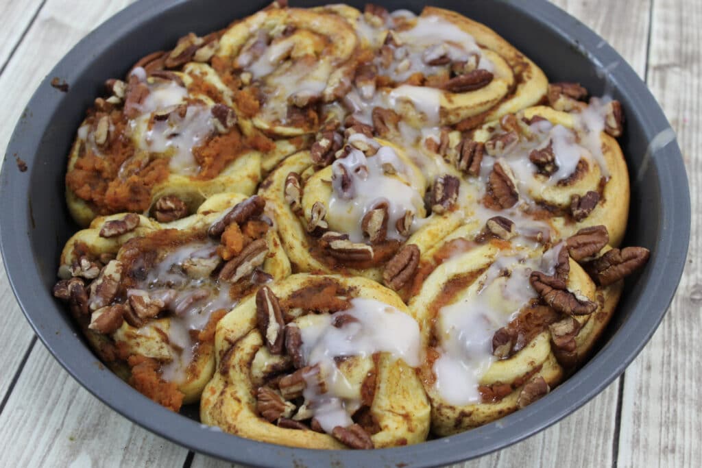 Pumpkin Cinnamon Rolls (3 Ingredients) 6 3 Ingredient Pumpkin Spice Cinnamon Rolls baked in round pan topped with icing.