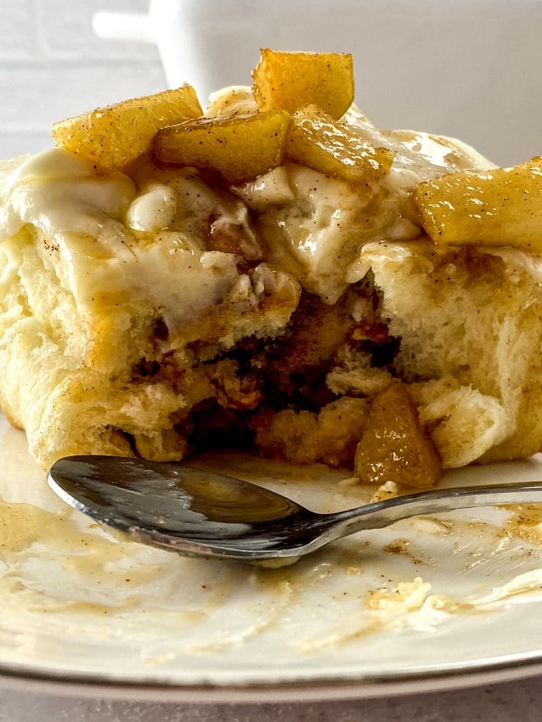 Delicious Apple Pie Cinnamon Rolls Recipe 15 close up of apple pie cinnamon roll with silver spoon