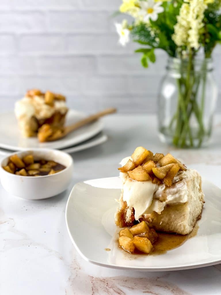 Delicious Apple Pie Cinnamon Rolls Recipe 14 apple pie cinnamon roll on white plate with flowers in background