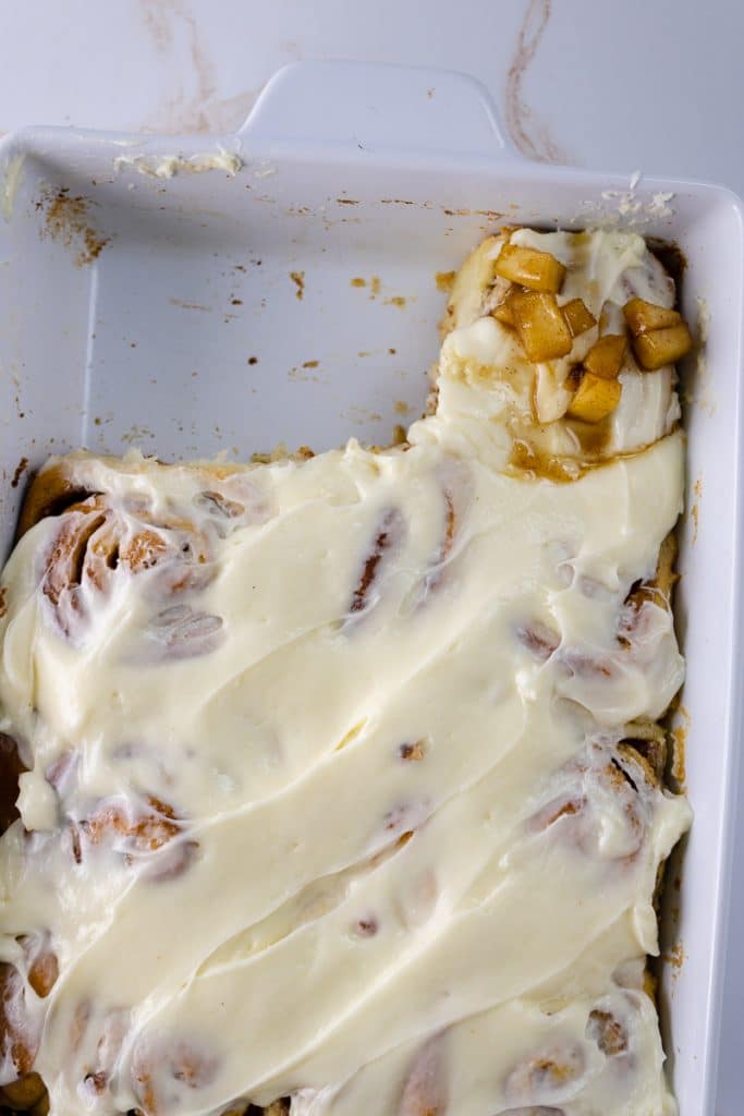 Delicious Apple Pie Cinnamon Rolls Recipe 13 apple pie cinnamon rolls covered with cream cheese in white dish