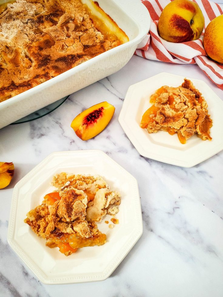 Easy Peach Dump Cake 7 peach dump cake on white plate with peaches garnish