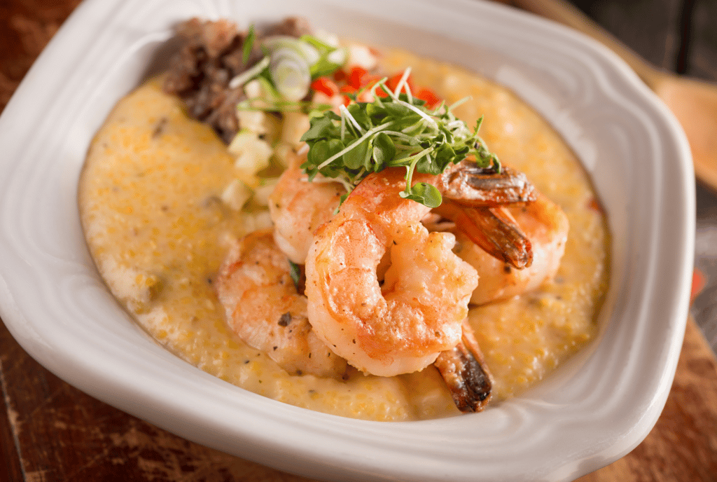 overhead view of shrimp and grits in white bowl