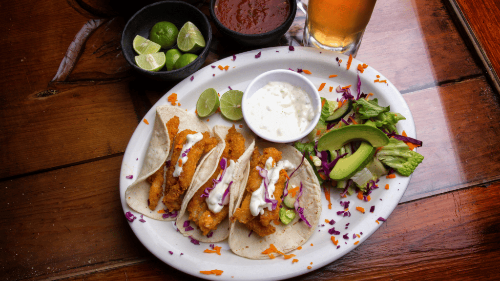 7 Delicious St. Augustine Seafood Restaurants You Must Visit Today 7 overhead view of fried fish tacos with lime and avocado