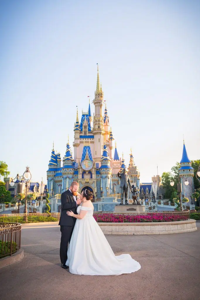 how to plan a Disney World Vow renewal bride and groom in front of Cinderella's castle 