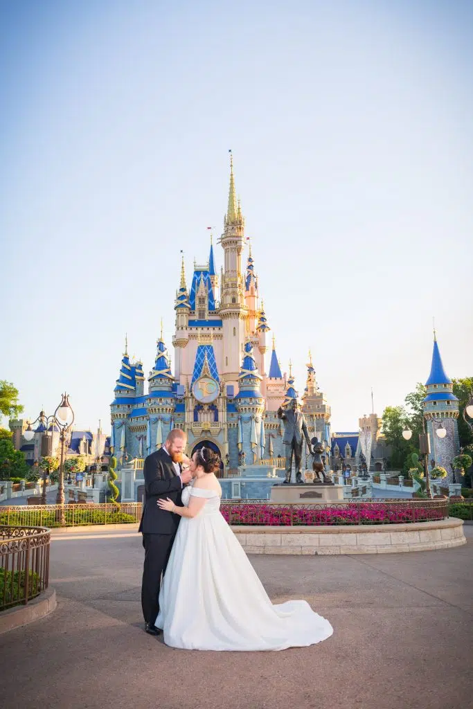 Everything You Need to Know About a Disney World Vow Renewal 4 how to plan a Disney World Vow renewal bride and groom in front of Cinderella's castle