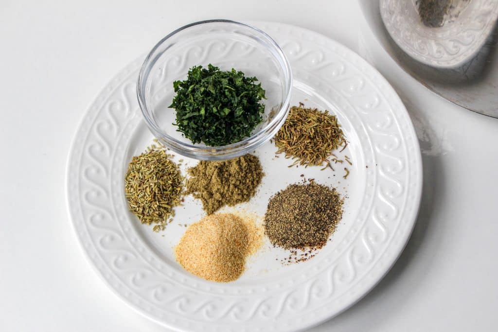 Quick Instant Pot Lemon and Herb Turkey Breast Recipe 12 clear bowl of fresh herbs on white plate with seasonings