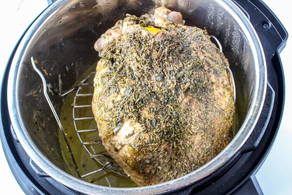 Quick Instant Pot Lemon and Herb Turkey Breast Recipe 14 whole turkey breast in instant pot with drippings below