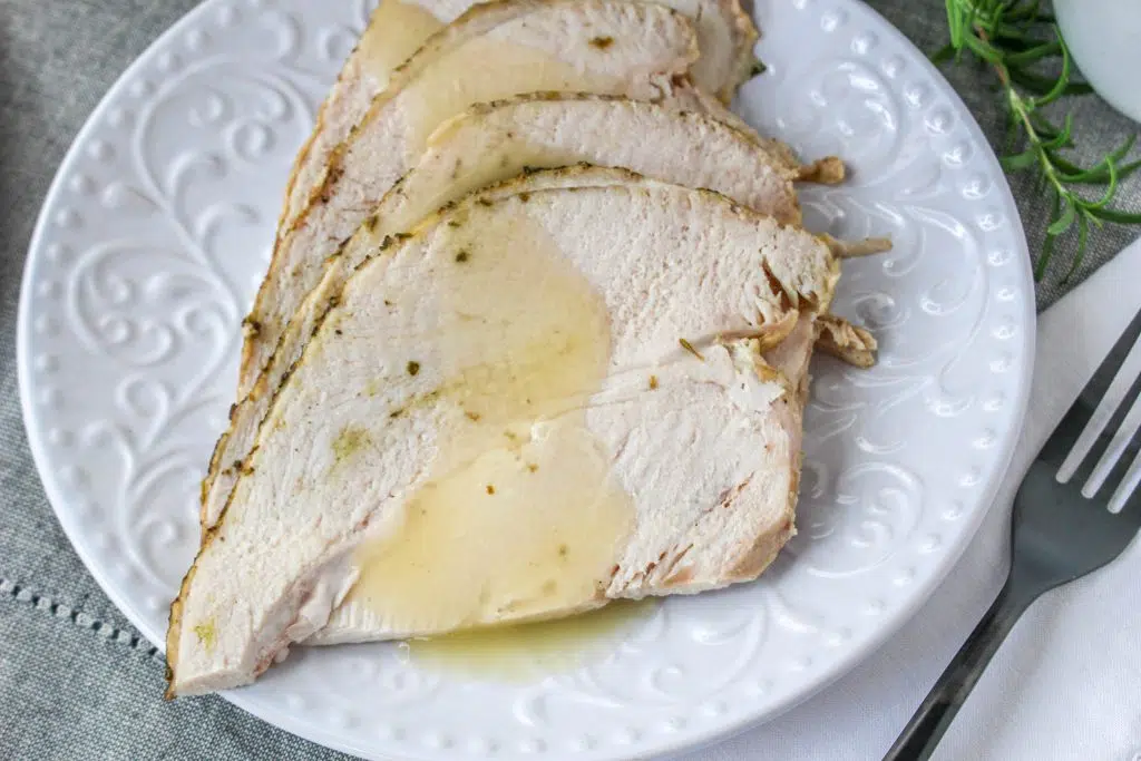 juicy sliced turkey breast with gravy on top