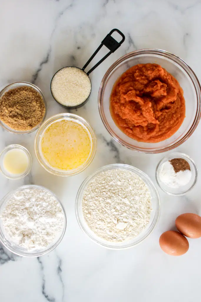 Ingredients for pumpkin donut holes on marble background.