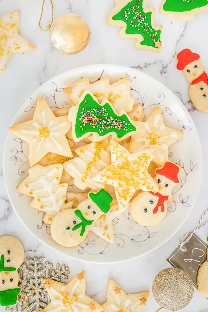 assorted christmas sugar cookies on white glass plate