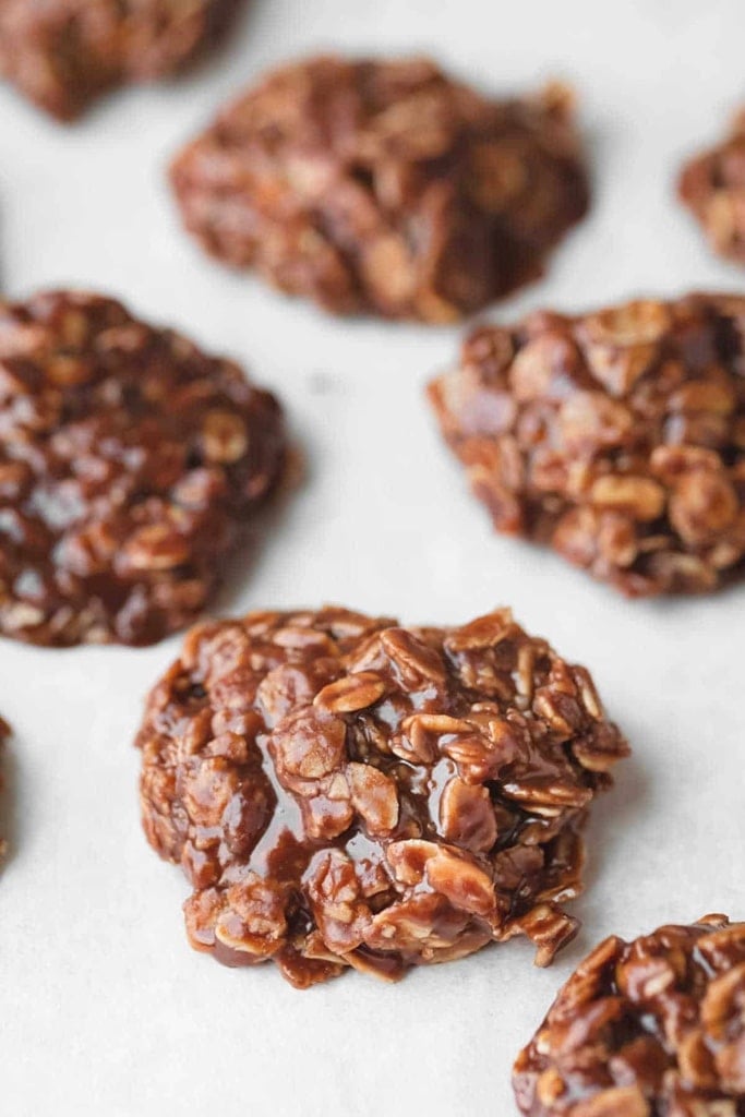 50 Easy Christmas Cookie Recipes with 7 Ingredients or Less 15 chocolate no bake cookies on white parchment paper