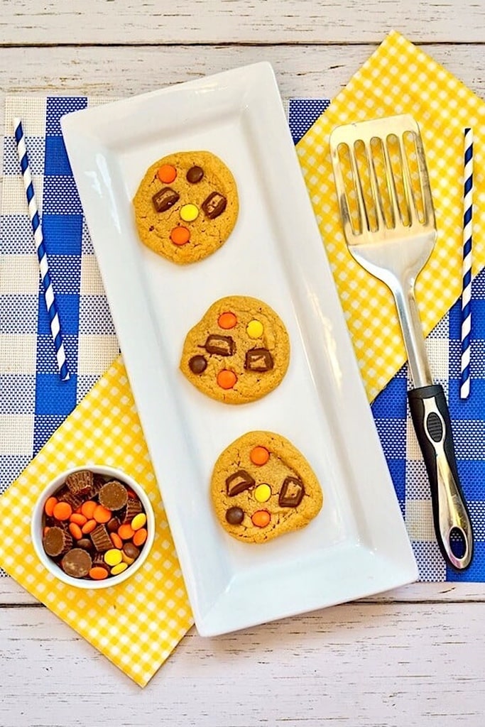 3 Reeses peanut butter cup cookies on white serving tray with spatula 