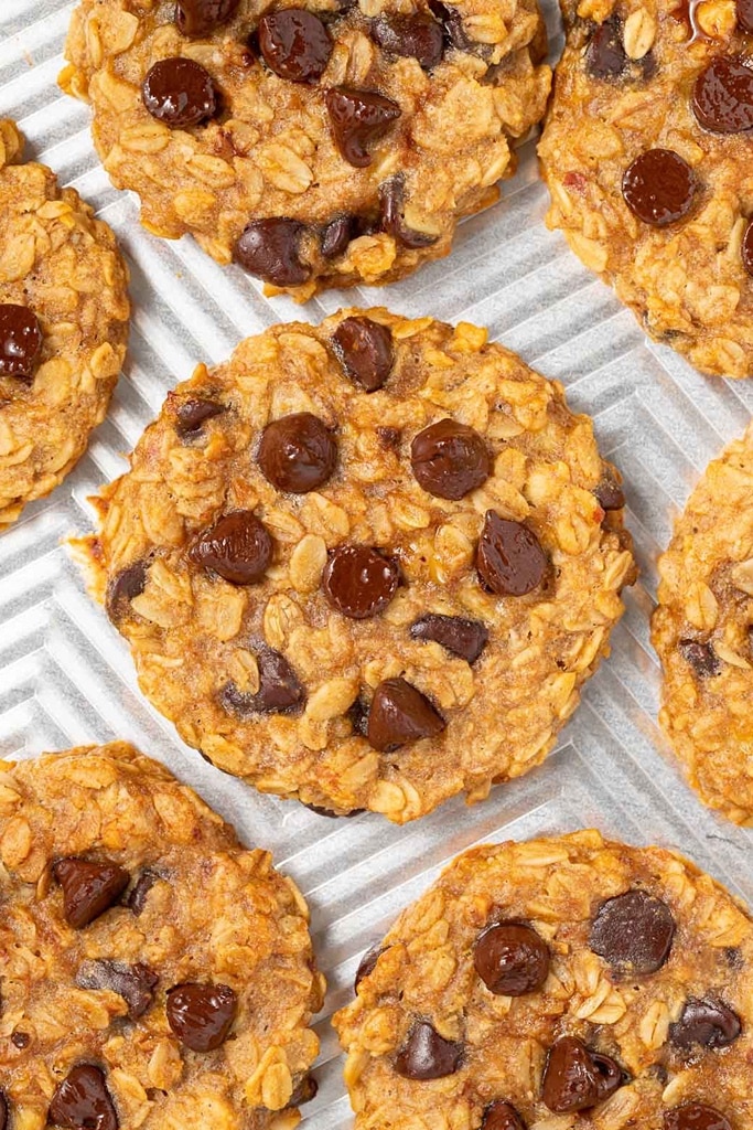 50 Easy Christmas Cookie Recipes with 7 Ingredients or Less 21 overhead view of peanut butter banana oatmeal cookies with melted chocolate chips