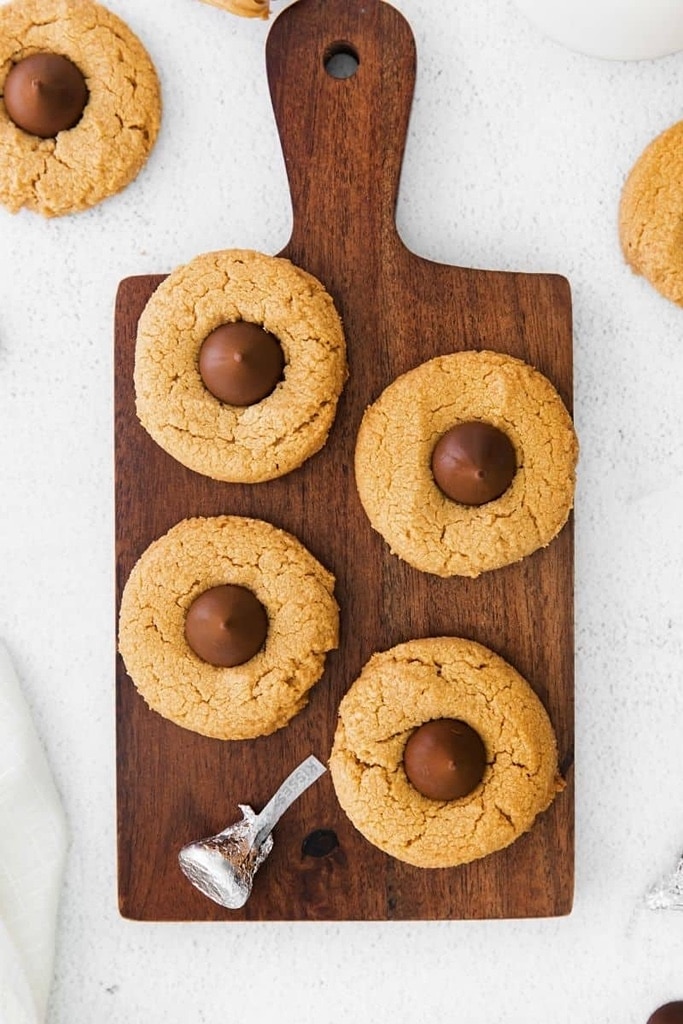 peanut butter blossom cookies on wooden serving tray 