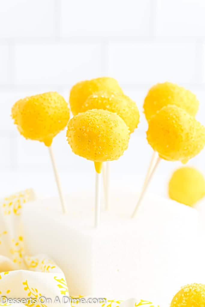 bright yellow lemon cake pops with yellow sprinkles 