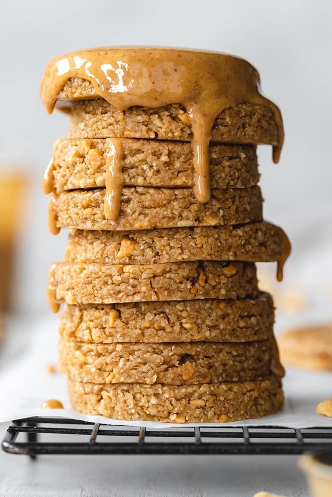 50 Easy Christmas Cookie Recipes with 7 Ingredients or Less 25 stack of perfectly circular peanut butter cookies with melted peanut butter dripping down