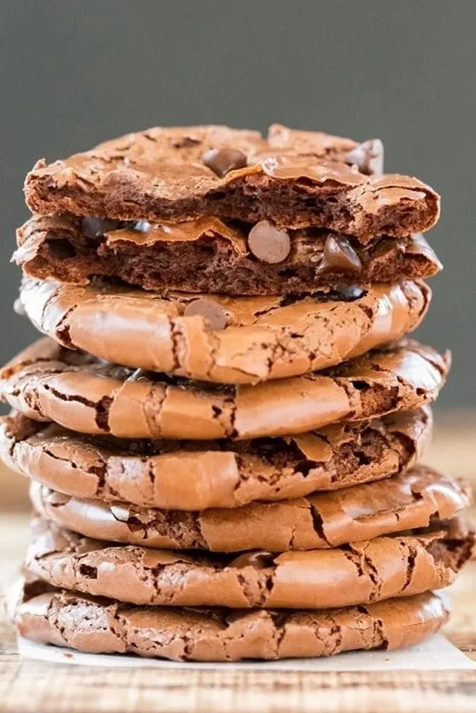 close up of stack of fudge cookies with one split in half 