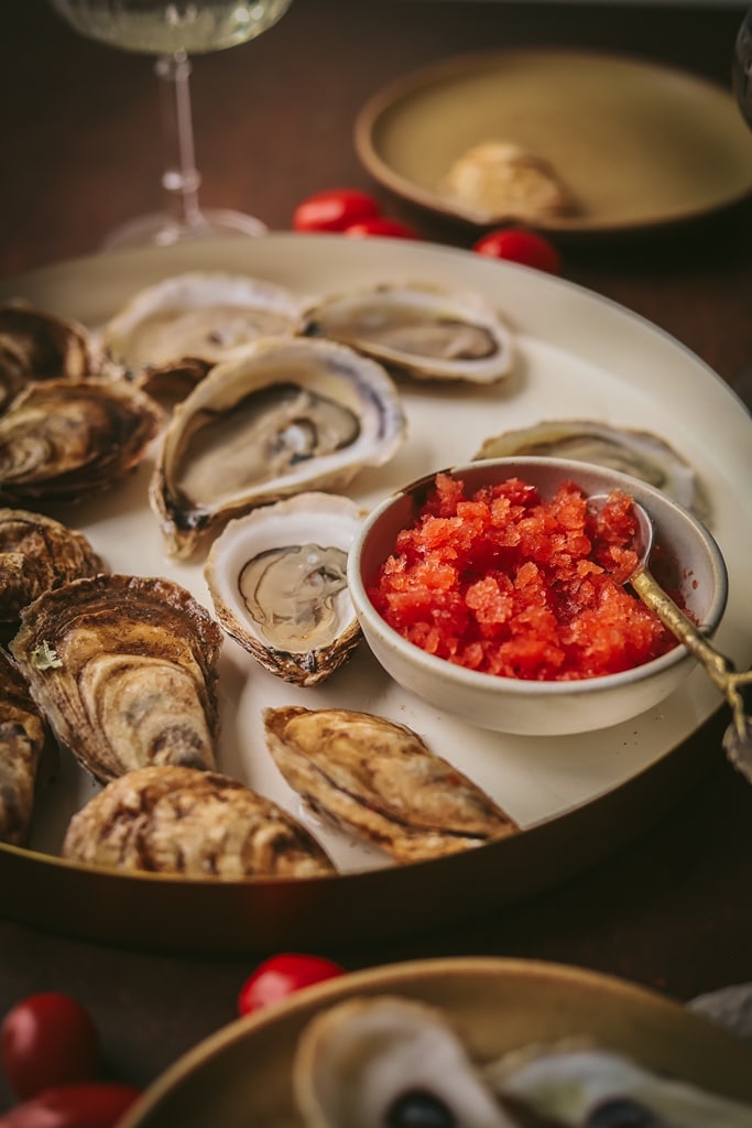 35 Party Appetizers For New Years Eve 8 small white serving dish of tomato vermouth with oysters on the side